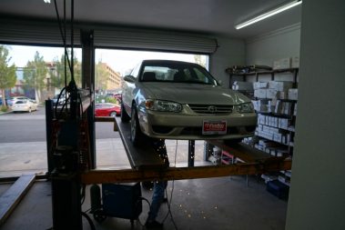 A car being fixed at the Muffler Shop